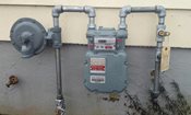 image of a natural gas meter outside of a home